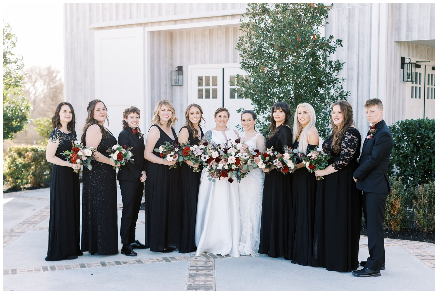 bridal party portrait black dresses with brides outside Arrowhead Hill