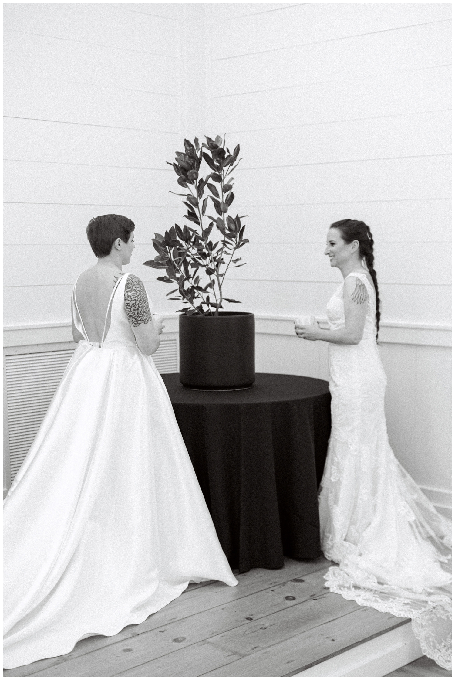 black and white of two brides during ceremony at Arrowhead Hill
