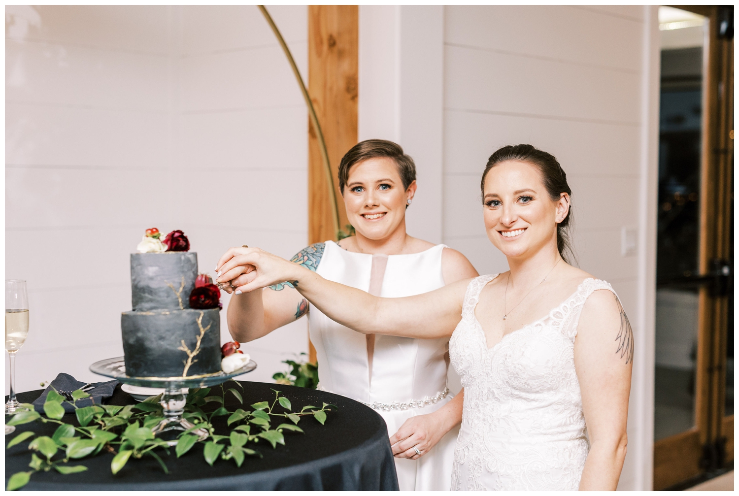 brides cutting black and gray wedding cake