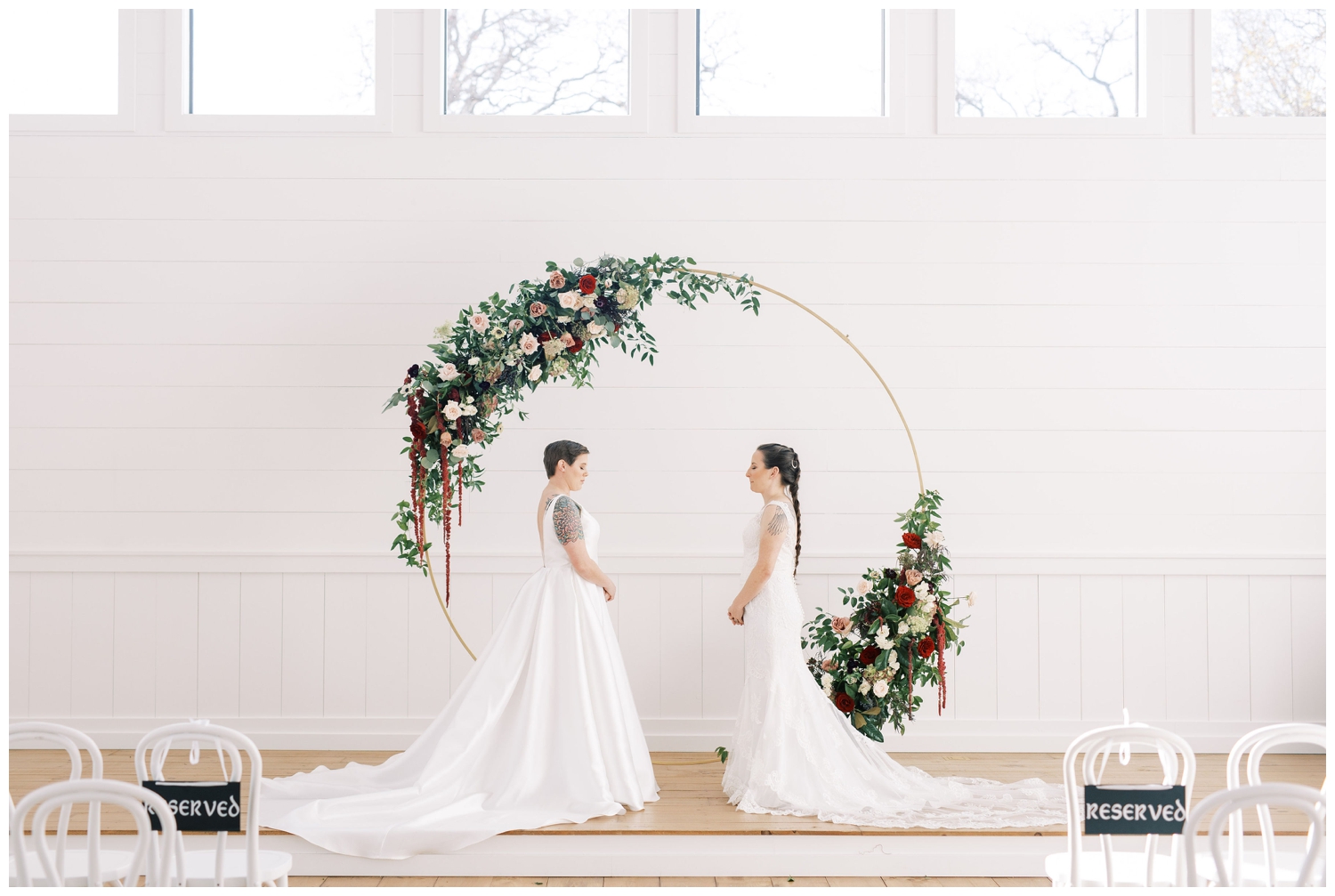 floral hoop inside Arrowhead Hill chapel with two brides having first look