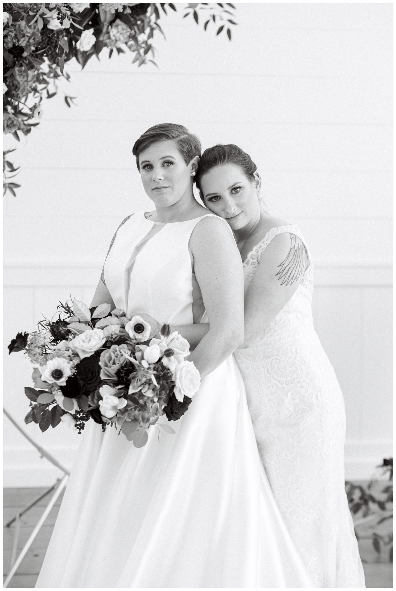 two brides posing for bridal portraits inside Arrowhead Hill in Montgomery Texas