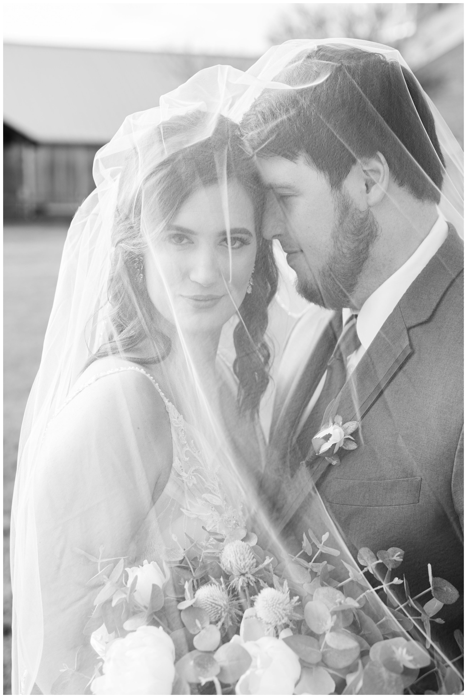black and white photo with newlyweds under the veil outside of Beckendorff Farms wedding
