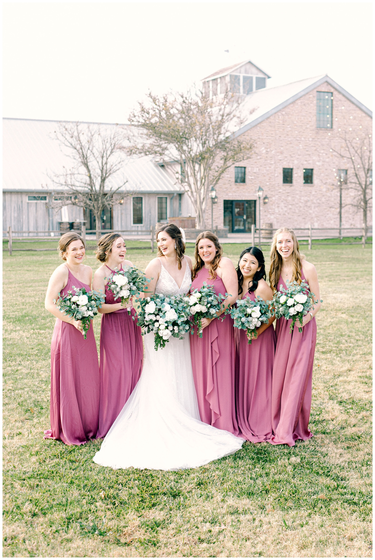 bride laughing with bridesmaids outside reception hall at Beckendorff Farms wedding