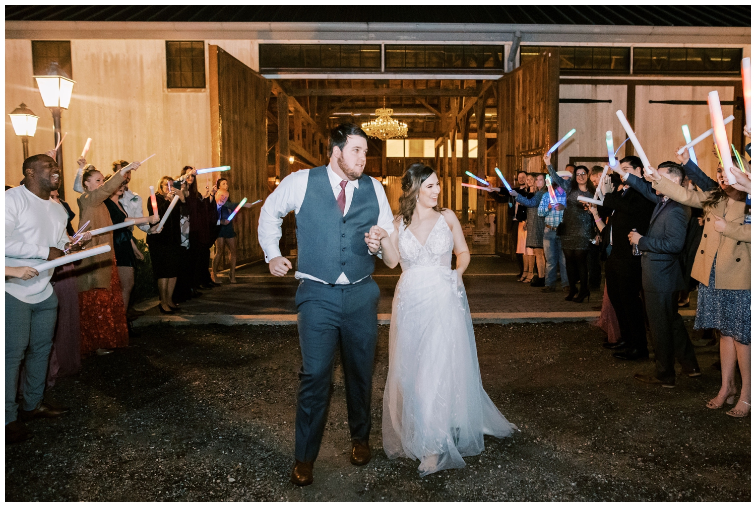 bride and groom running through reception exit line