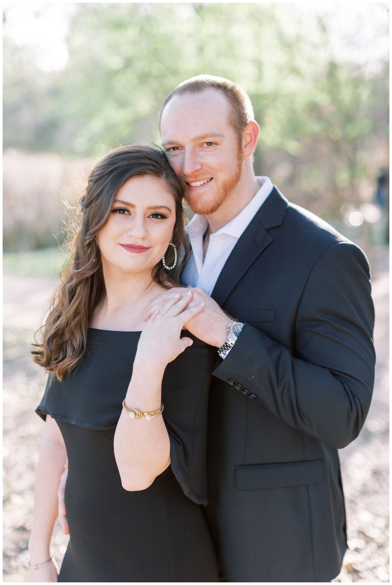 engaged couple in black formal wear outdoor portrait