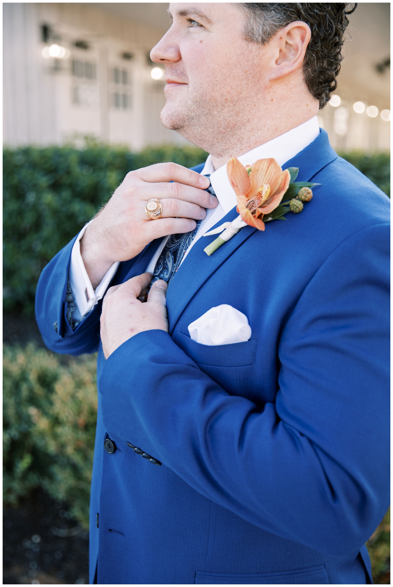 groom straightening his tie outside Arrowhead Hill Wedding venue