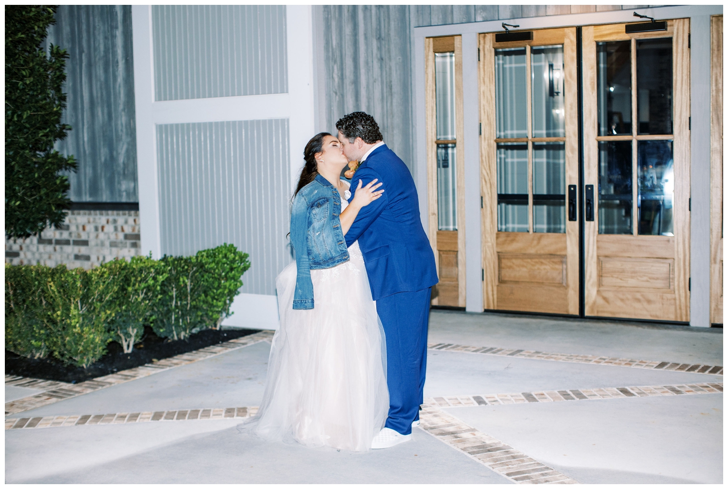 bride and groom kissing outside Arrowhead Hill wedding venue