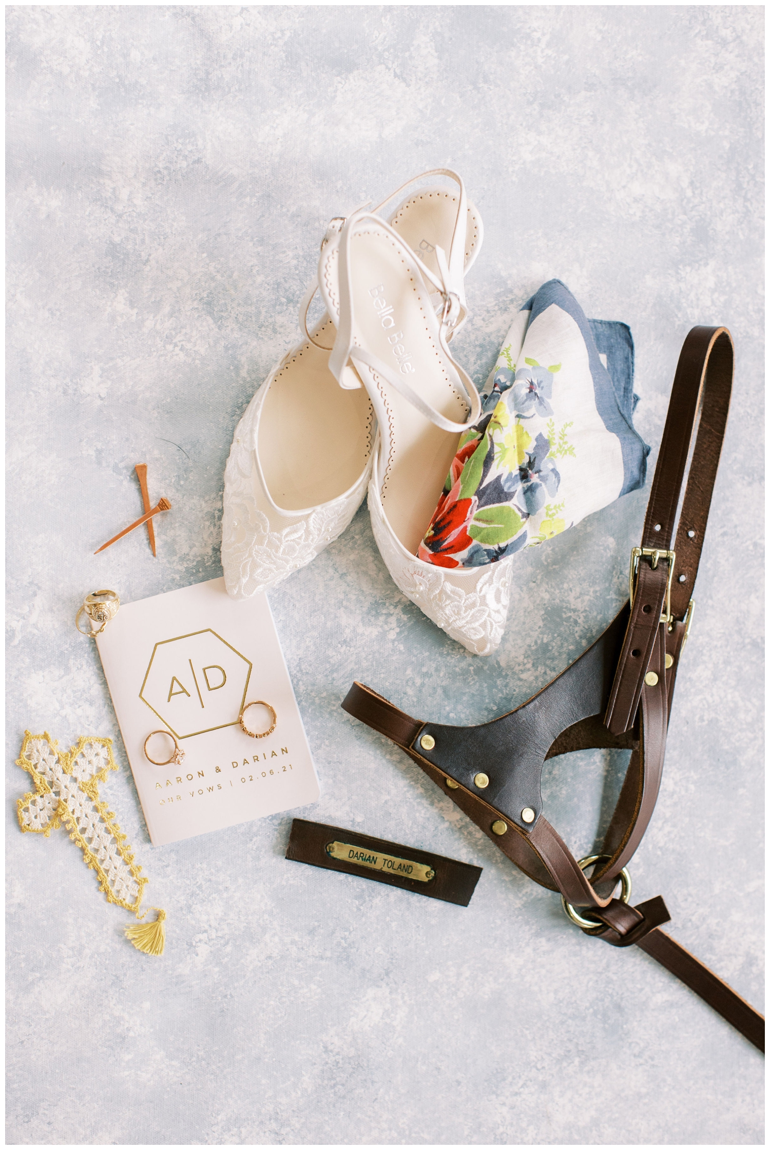 bride details with shoes and vow book