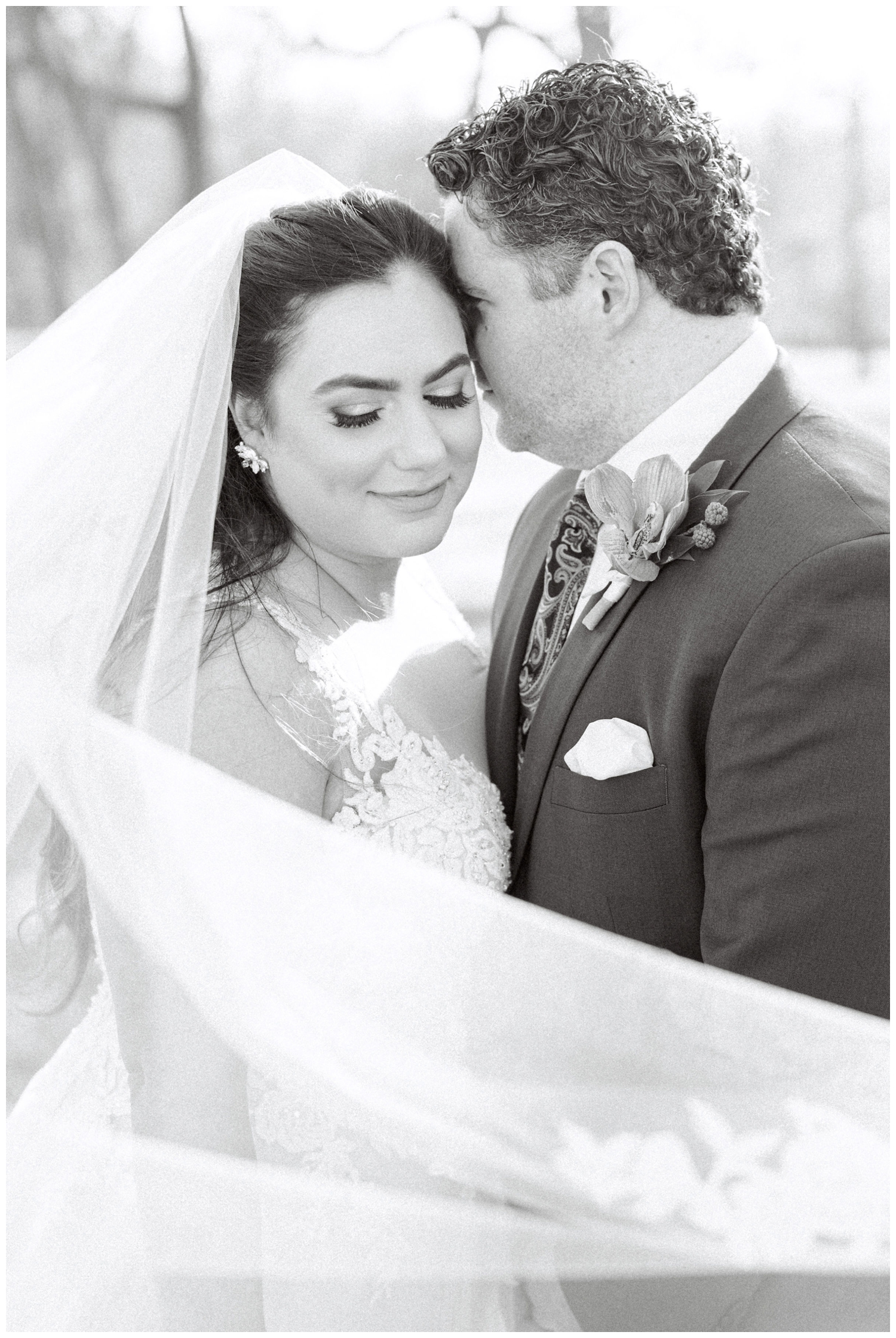 black and white photo of bride groom veil swoop