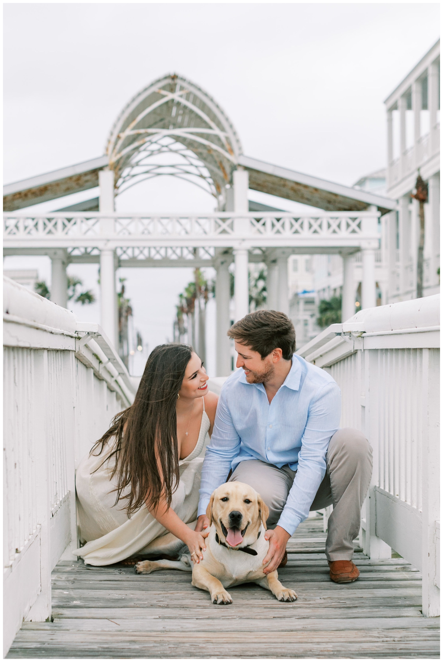 couple portrait with dogs on boardwalk for Galveston engagement session