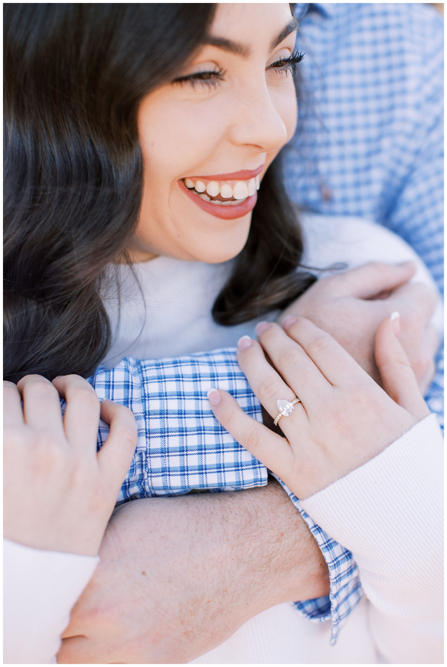 wedding ring closeup with bride smiling