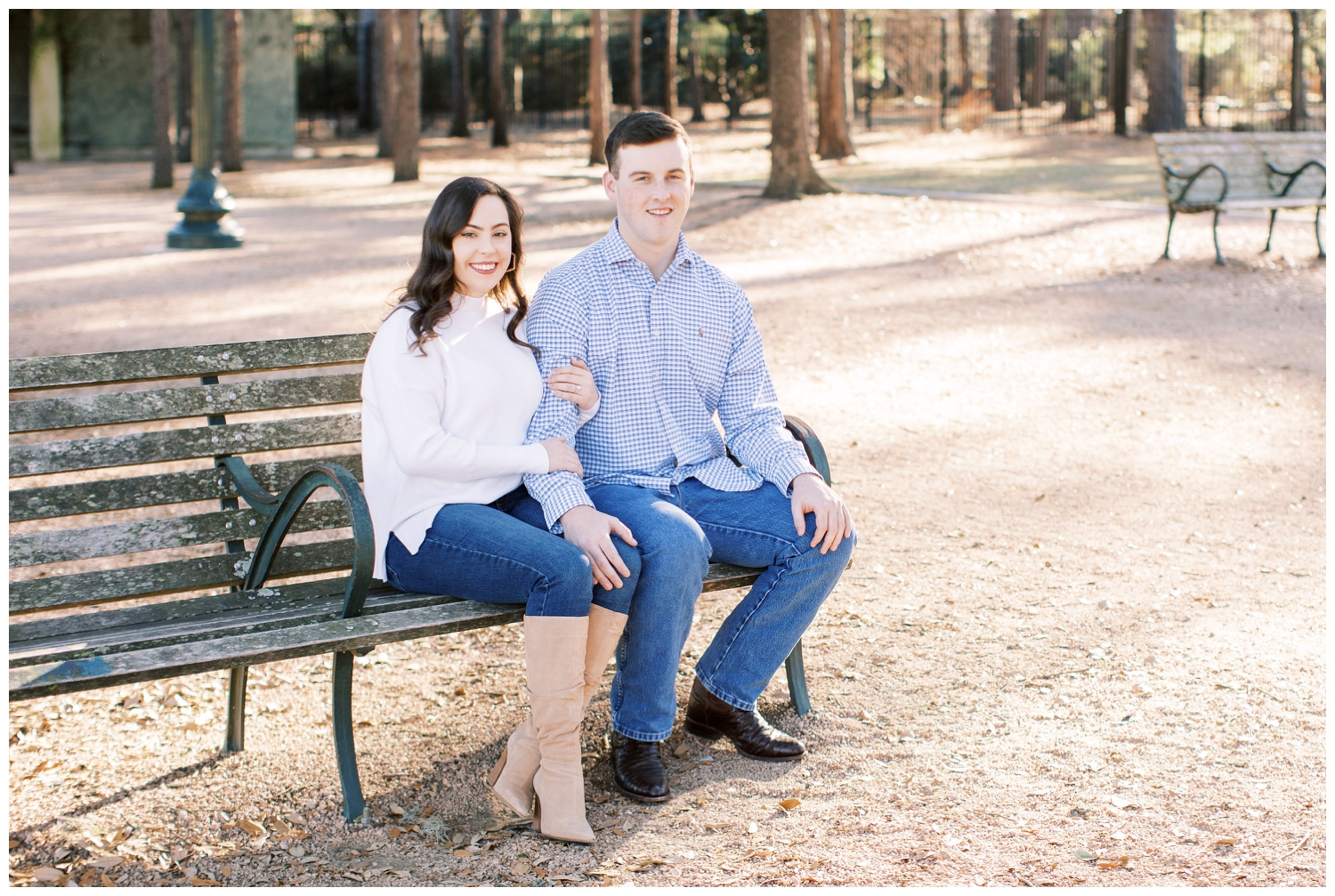 couple sitting on bench at Hermann Park Houston engagement session