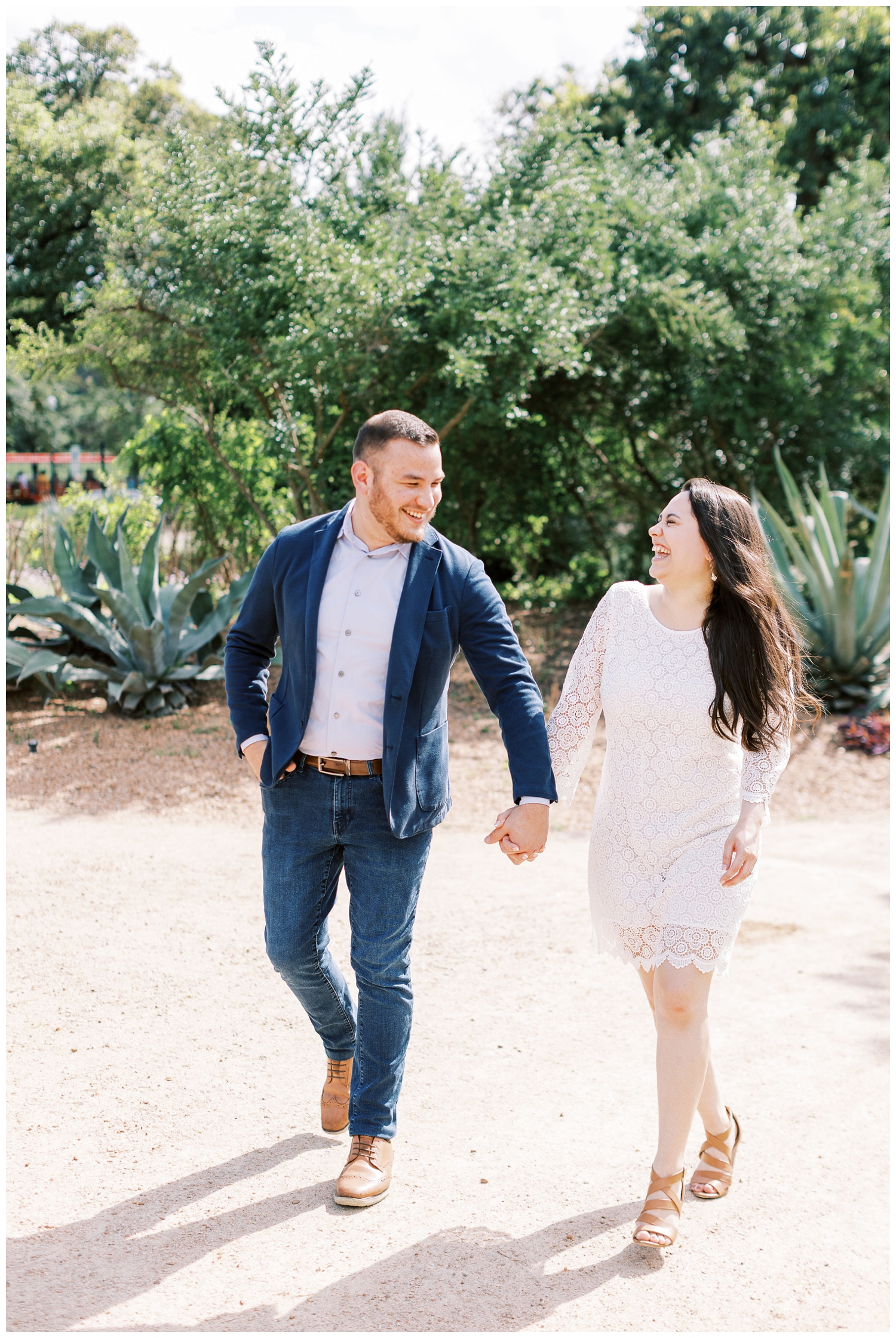 couple holding hands and laughing at McGovern Centennial Gardens engagement session
