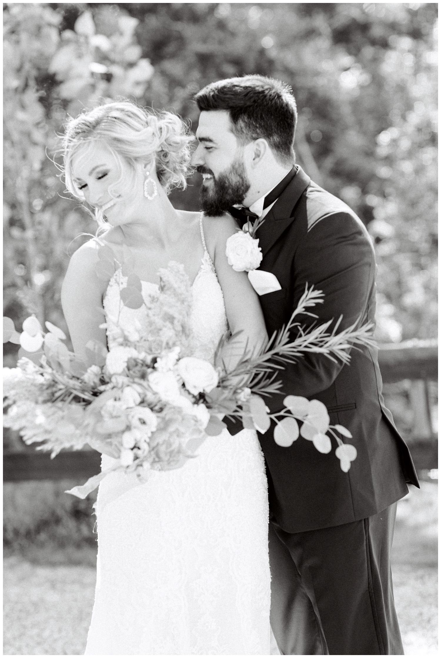 black and white portrait of newlyweds hugging on the grounds Peach Creek Ranch Wedding venue