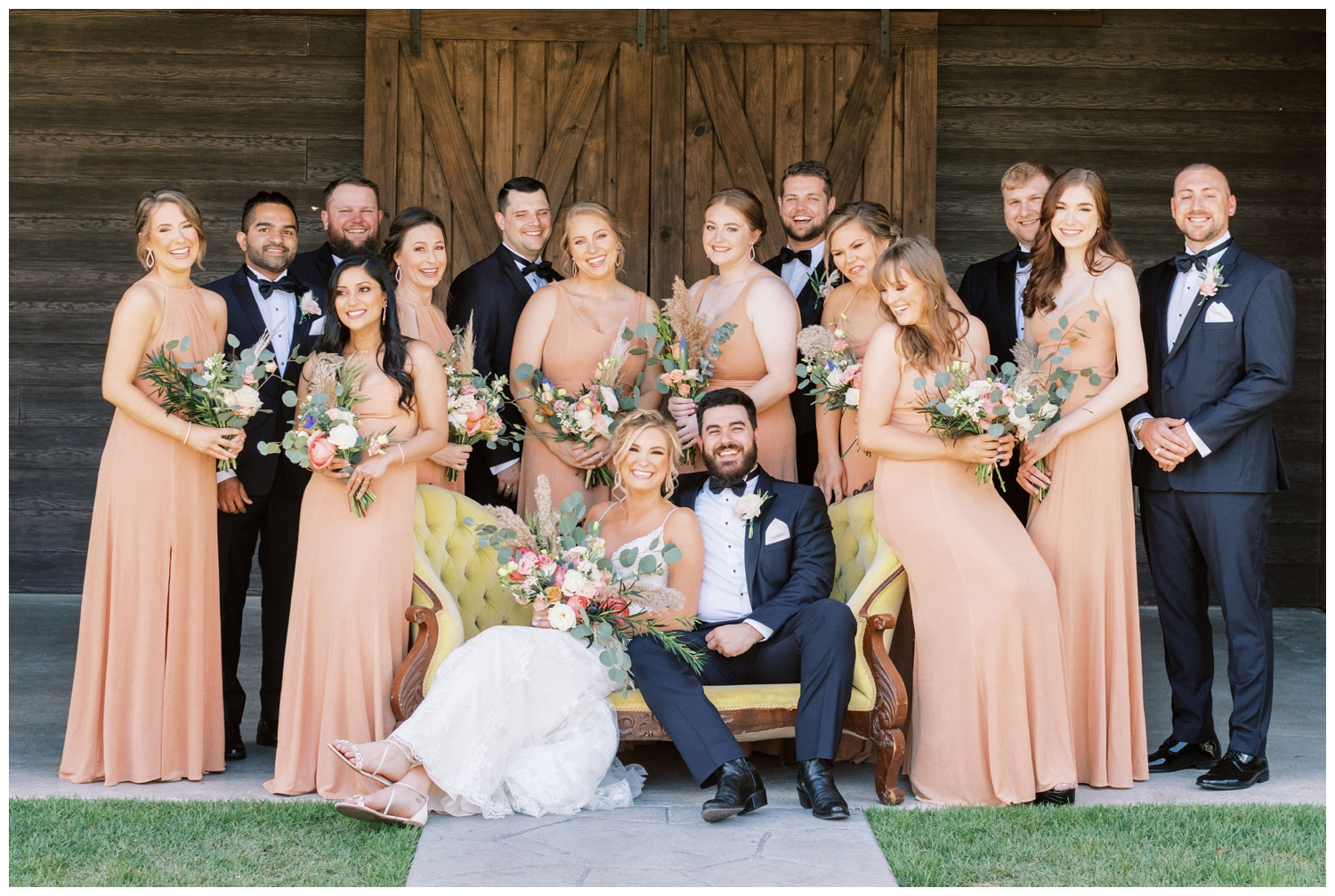 bride and groom and bridal party sitting on yellow couch in College Station at Peach Creek Ranch Wedding venue