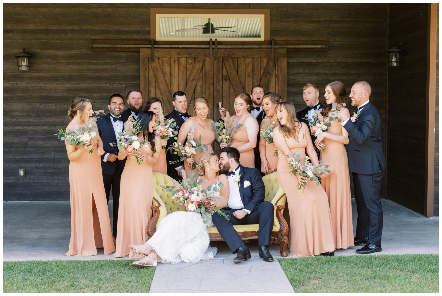 bride and groom with bridal party in peach dresses
