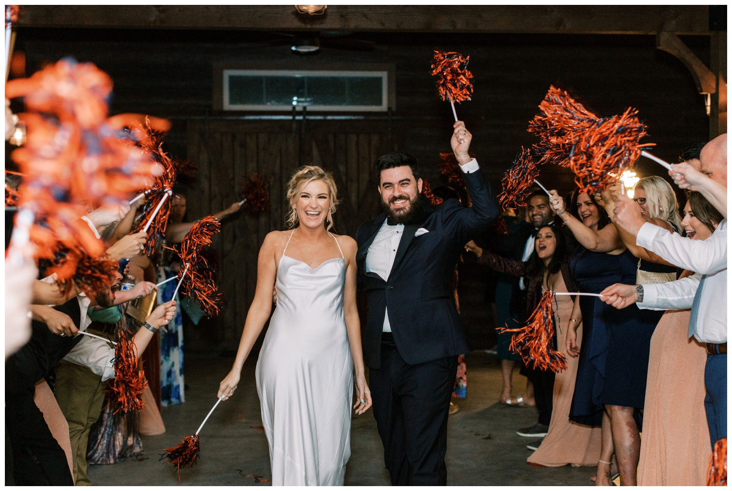 bride and groom walking through pom poms to exit wedding reception at Peach Creek Ranch wedding