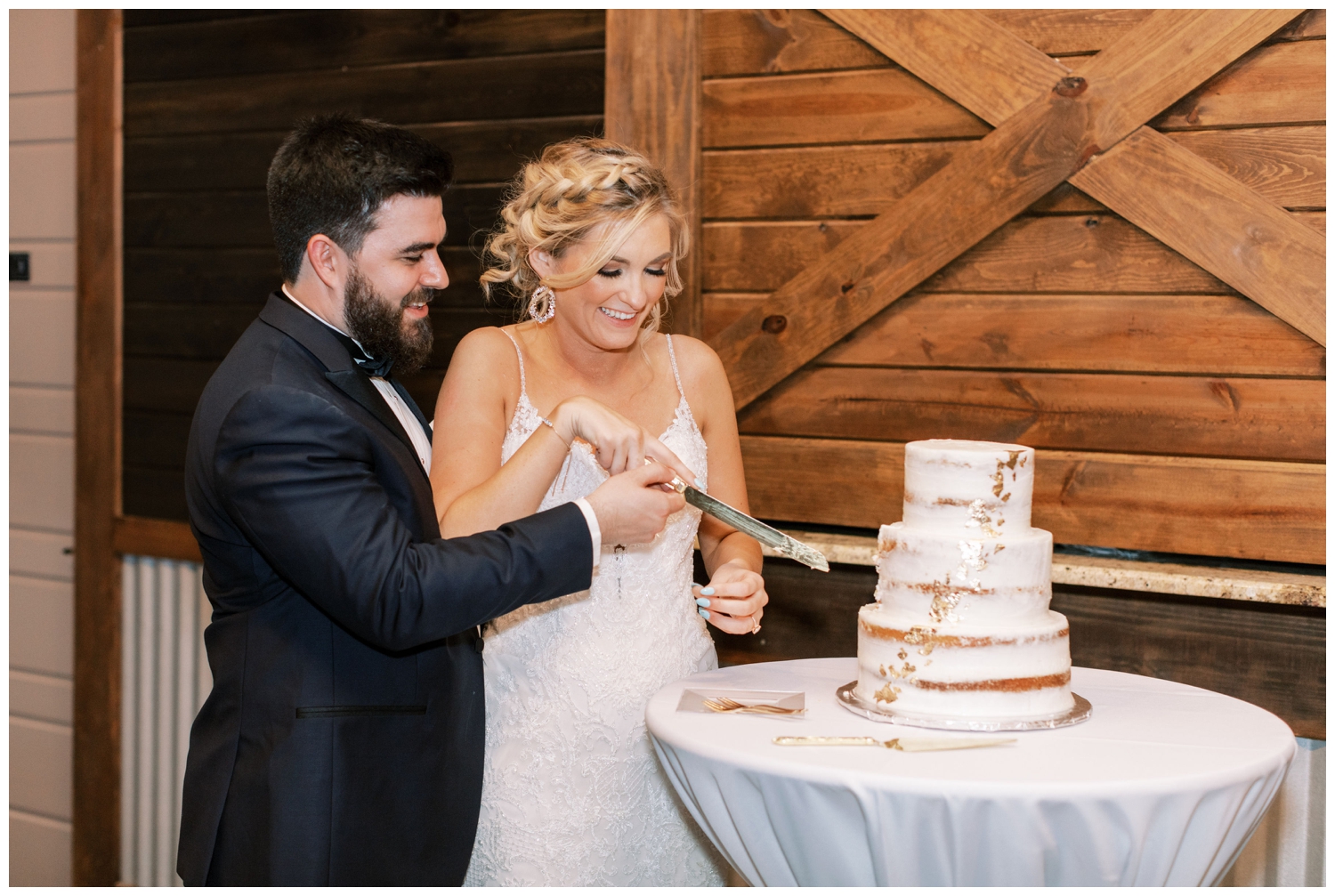 bride and groom cutting all white cake at reception at Peach Creek Ranch wedding