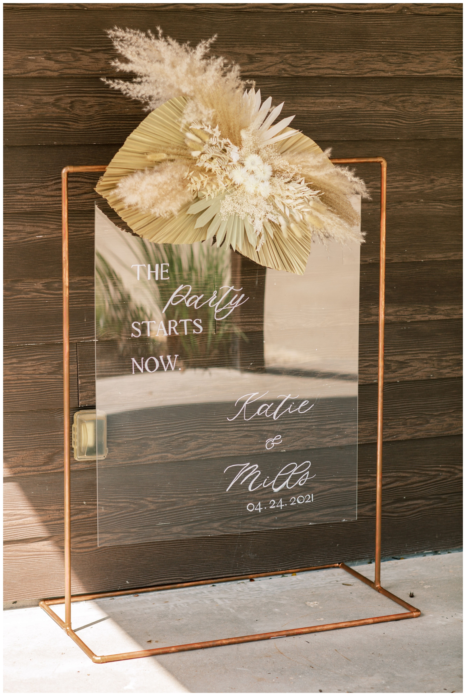 glass welcome sign with calligraphy and feathers
