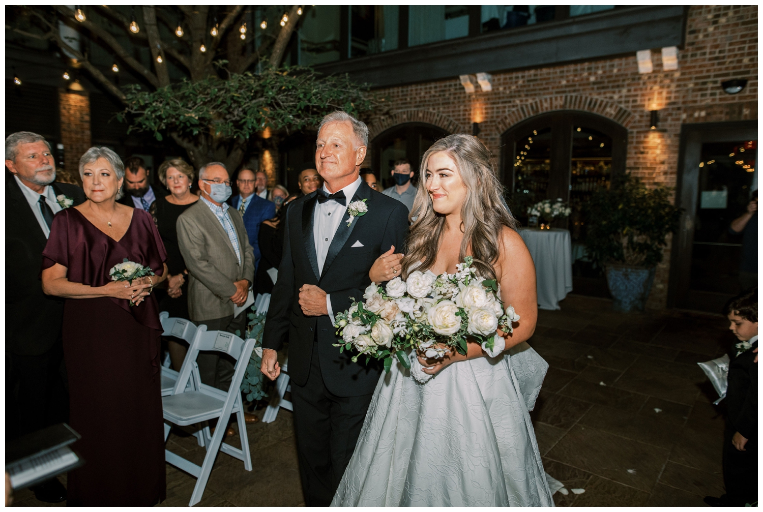 father escorting bride down the ceremony aisle at outdoor ceremony at Brennans