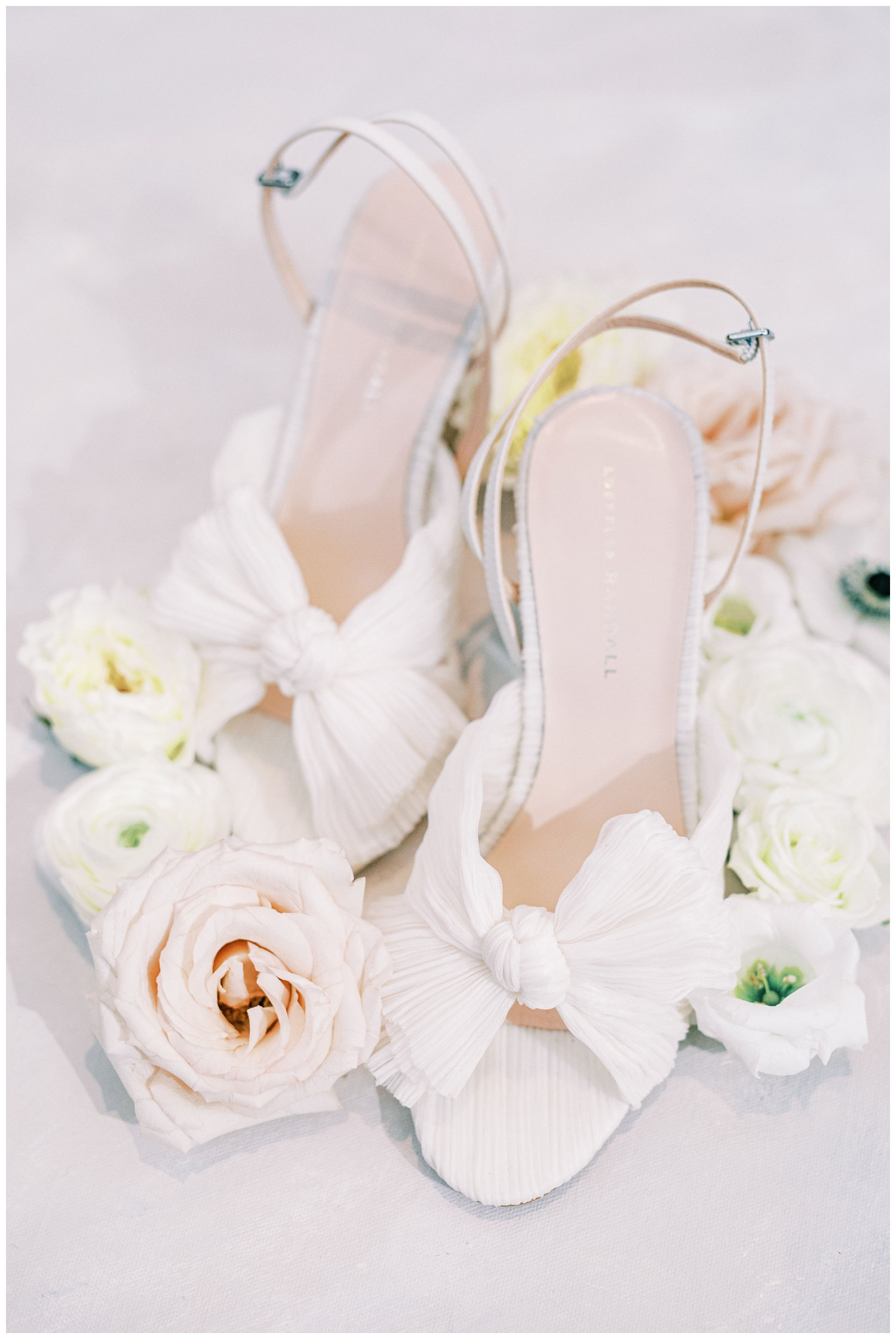 white bridal heels surrounded by florals for a flat lay inside the Houstonian hotel
