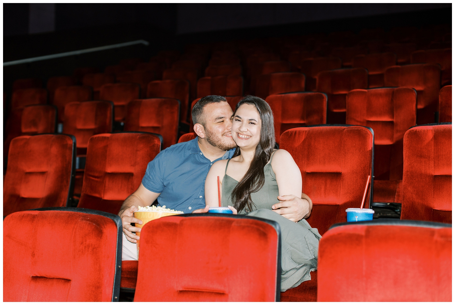 couple kissing inside movie theater