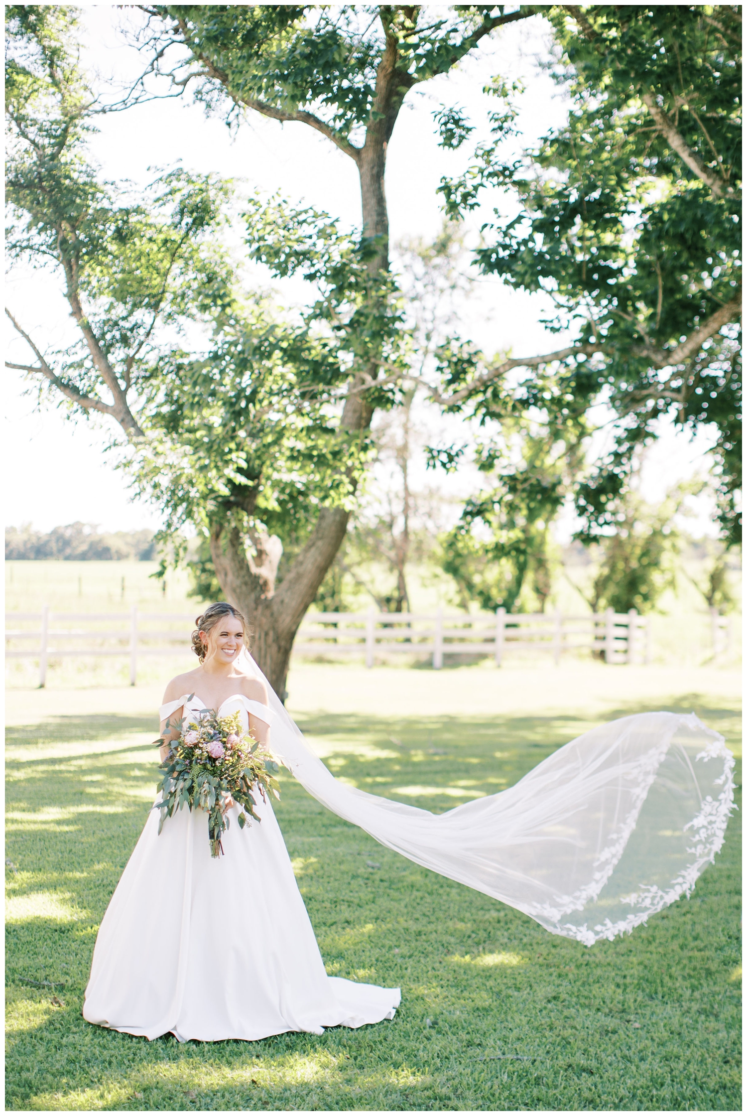 bridal portrait with veil toss at The Grand Texana Houston white barn wedding