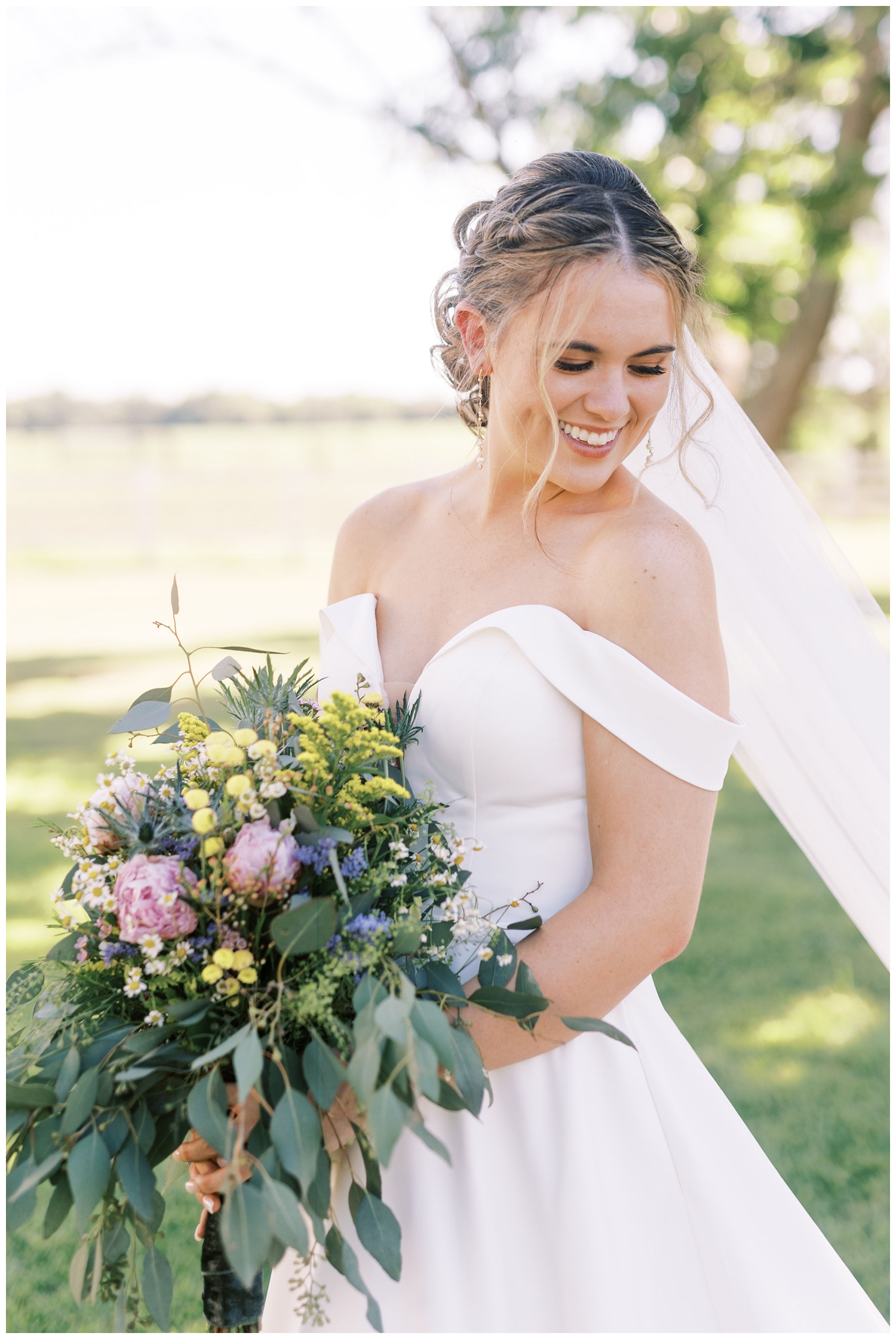bride standing outdoors with bouquet at The Grand Texana