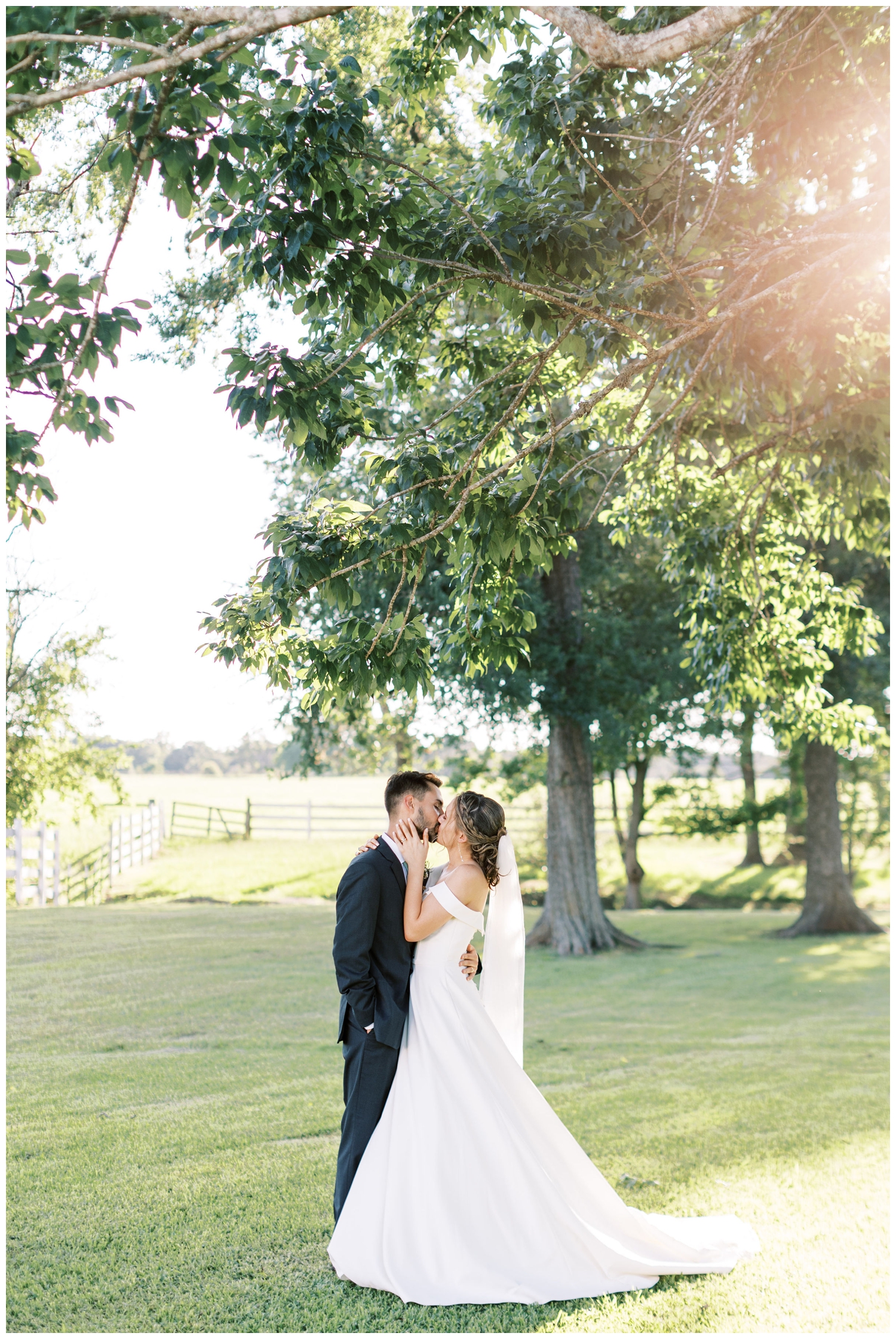 bride and groom kissing under a tree at The Grand Texana