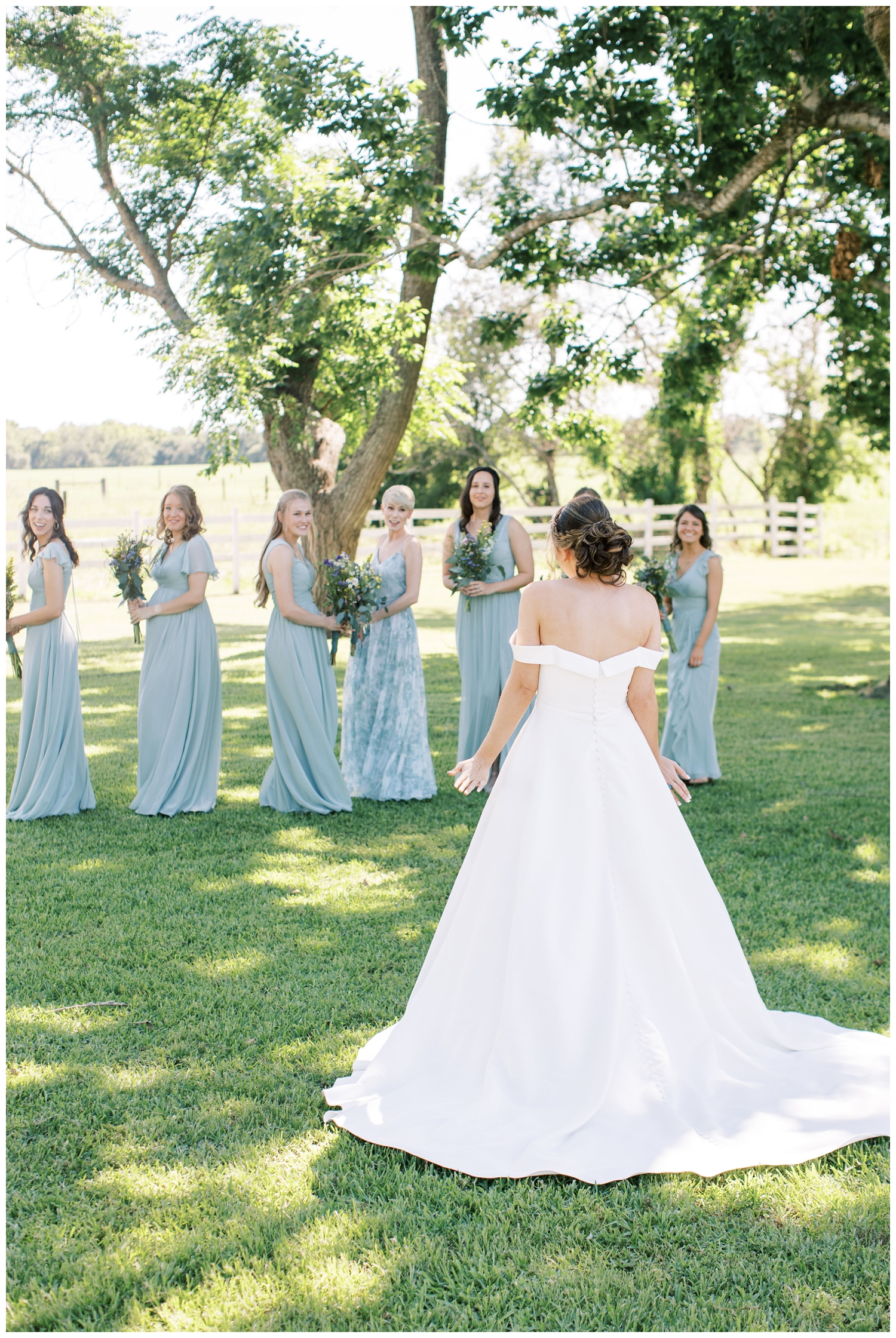 brides first look at Houston white barn wedding with bridesmaids