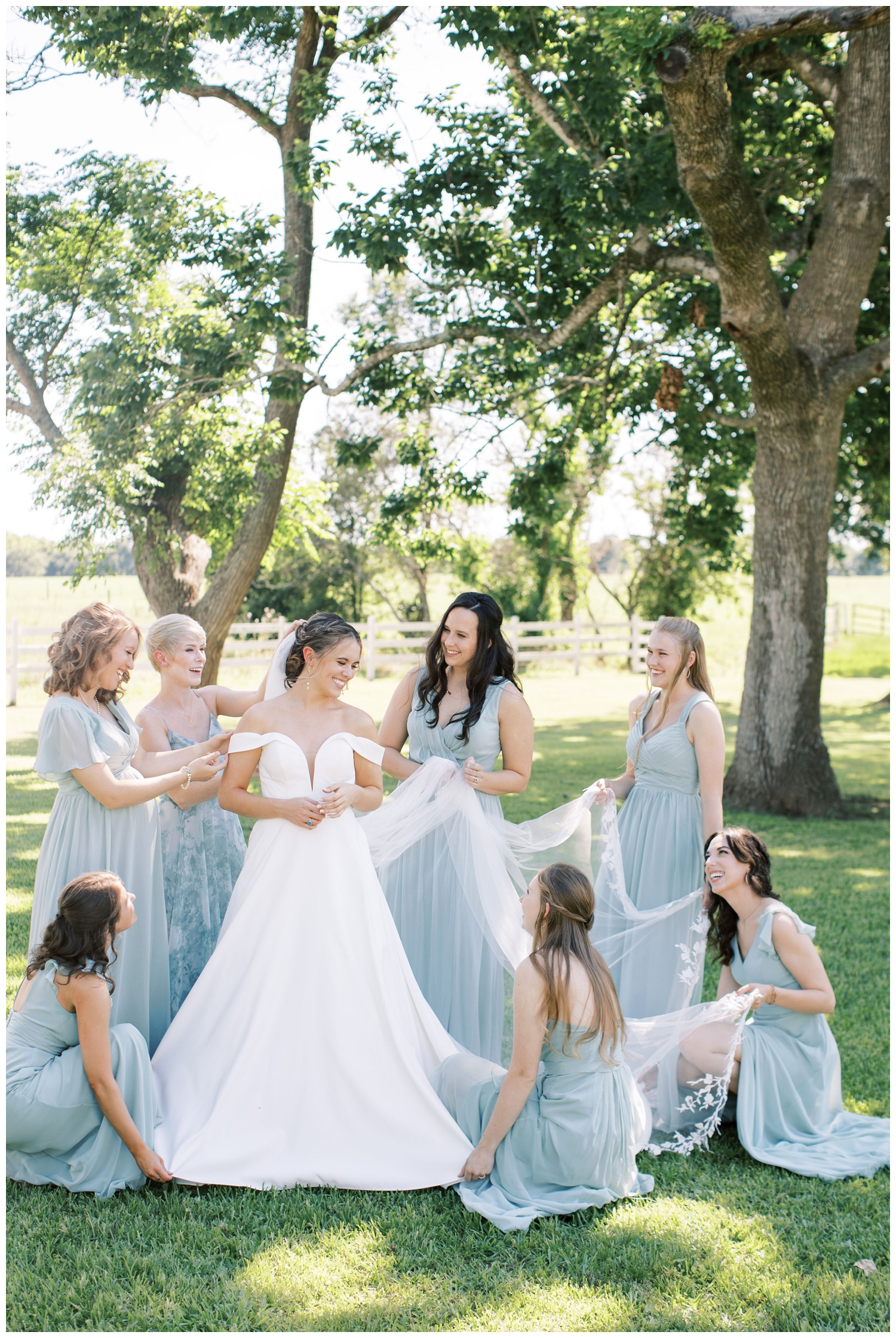 bridesmaids fluffing veil outdoors at The Grand Texana