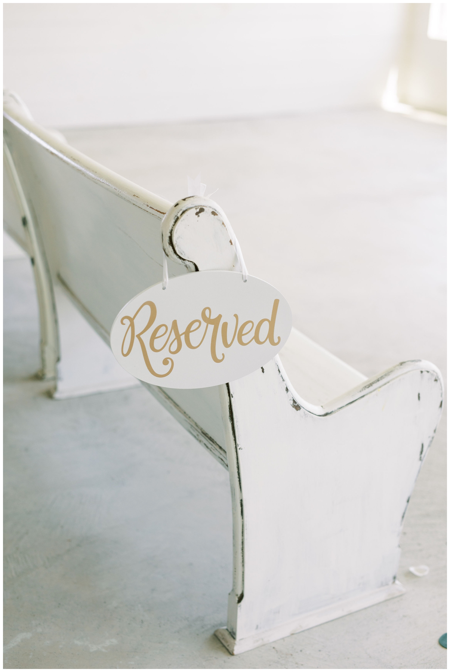 white barn chapel pew with reserved sign