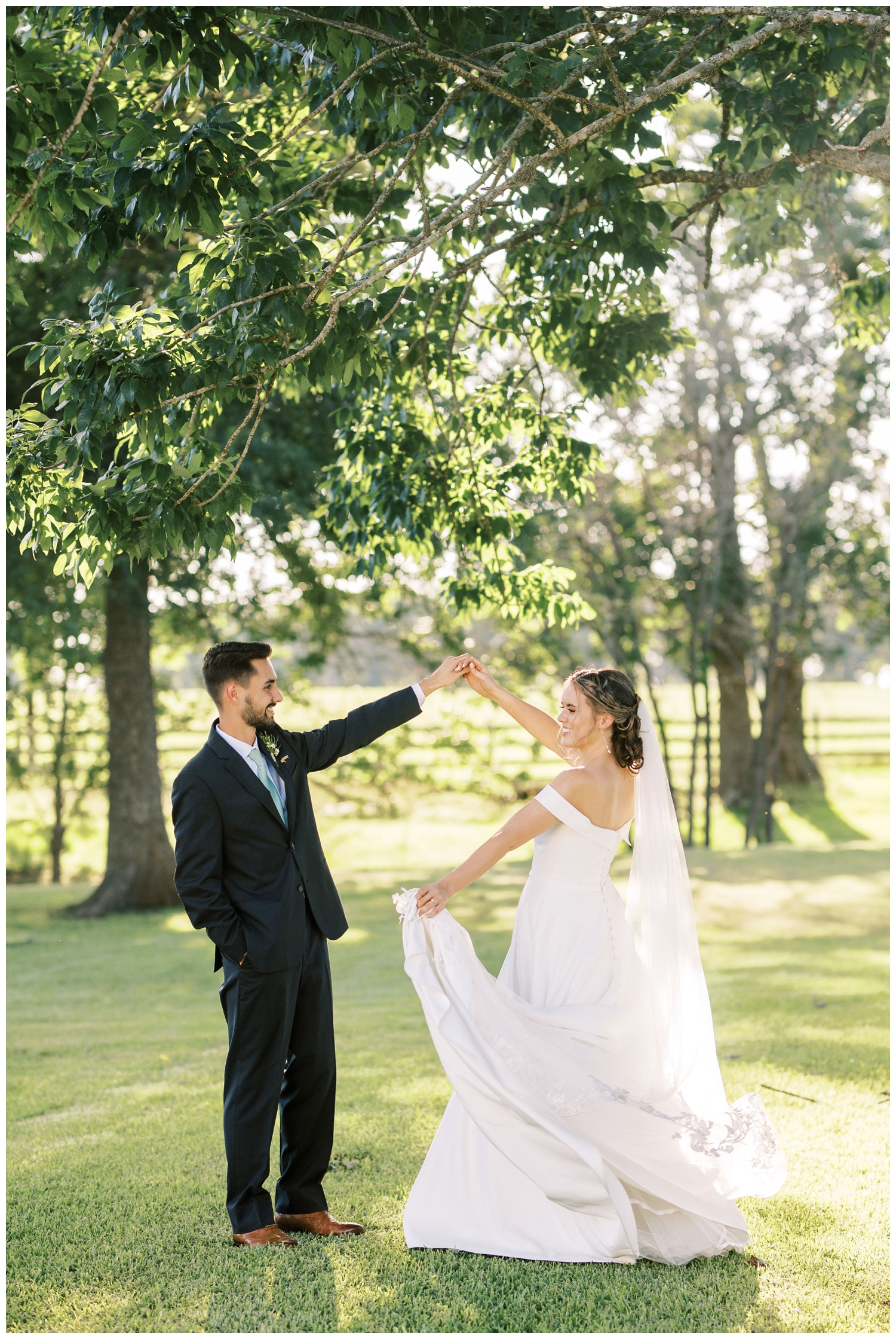 groom twirling his bride at sunset at Houston white barn wedding