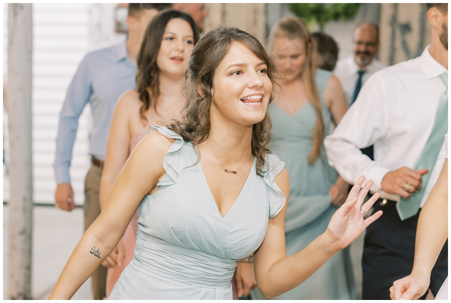 guest dancing at Houston white barn wedding reception