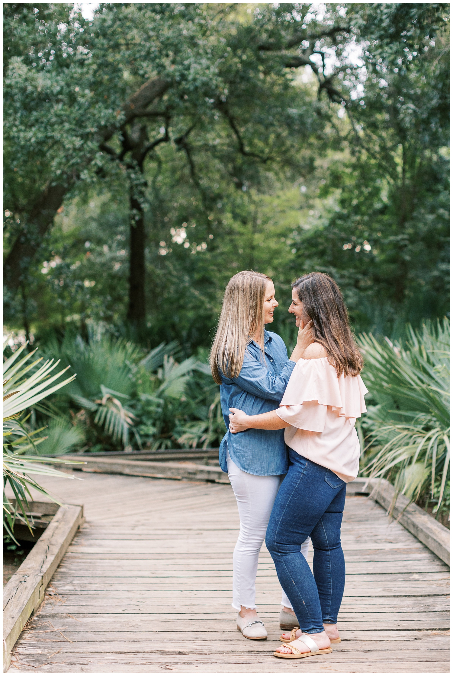 two brides embracing for Houston engagement session at Hermann Park