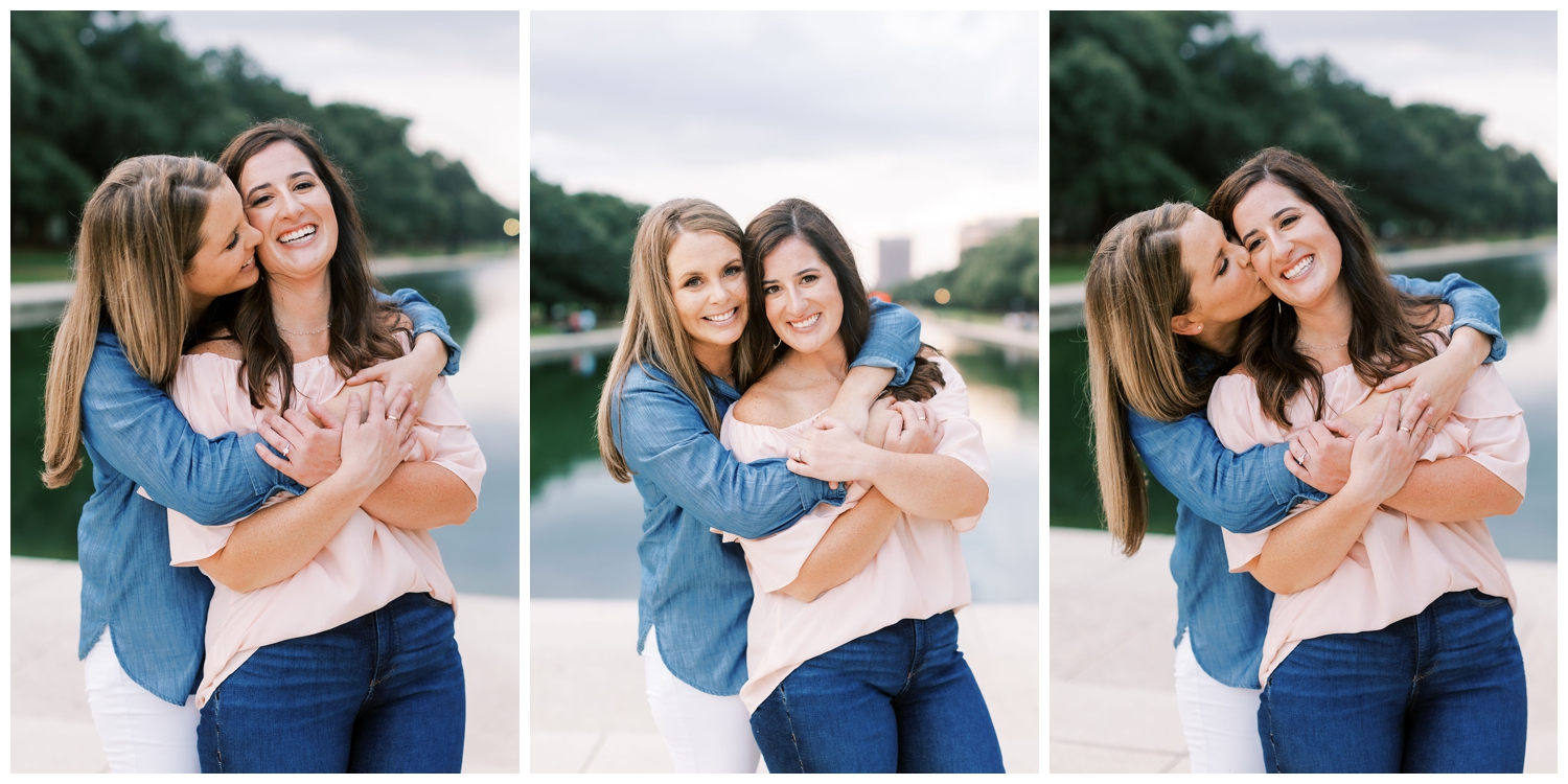 Houston engagement session with same sex couple hugging in front of water inside Hermann Park