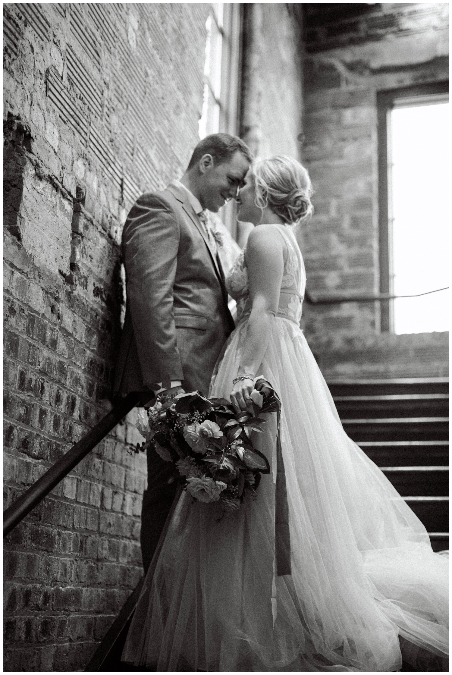 black and white photo bride and groom in stairwell