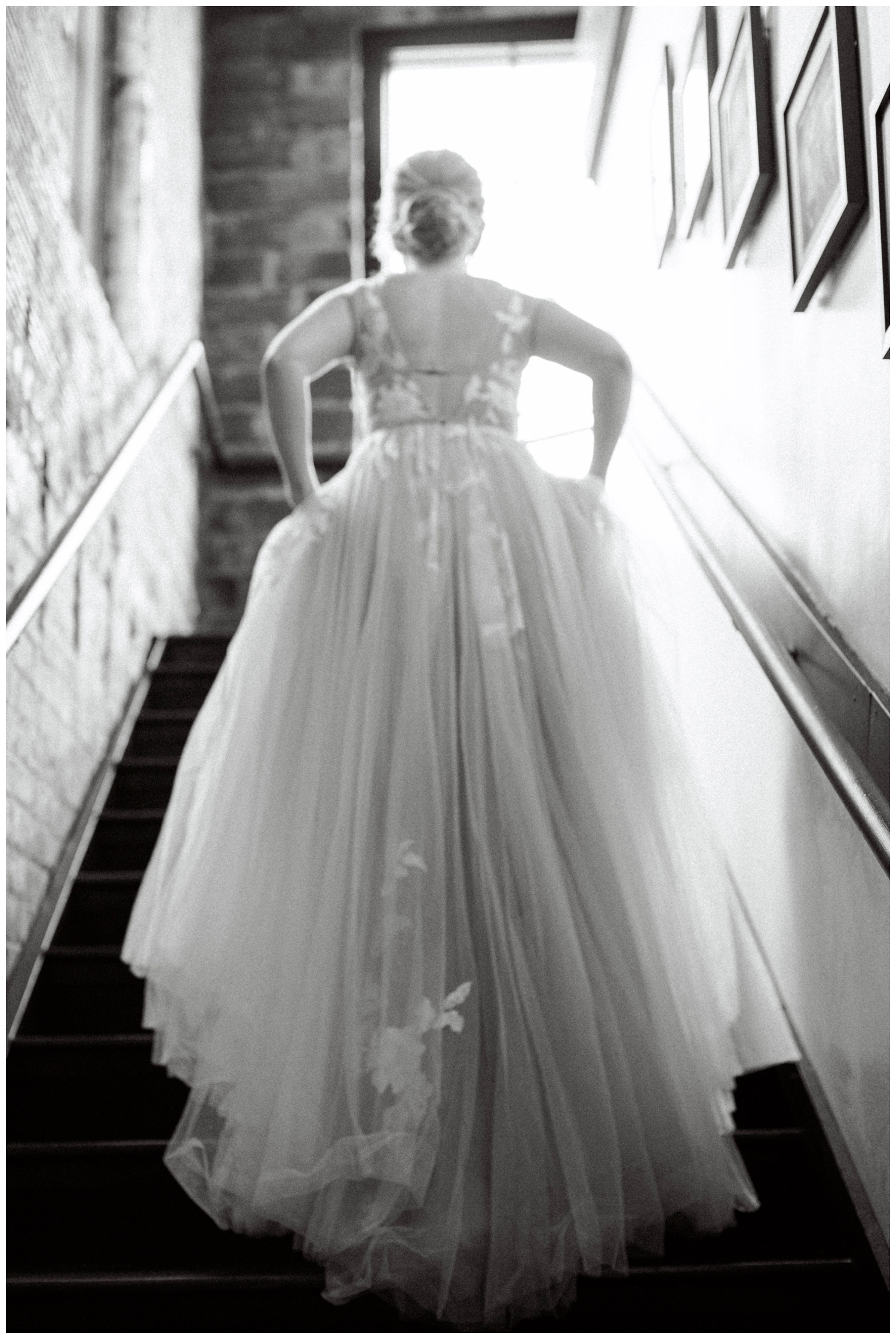 black and white photo bride walking up stairs