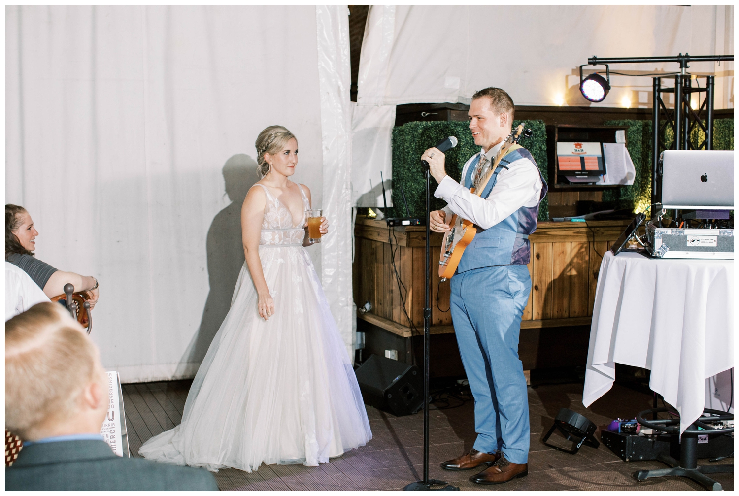 groom playing guitar and serenading bride