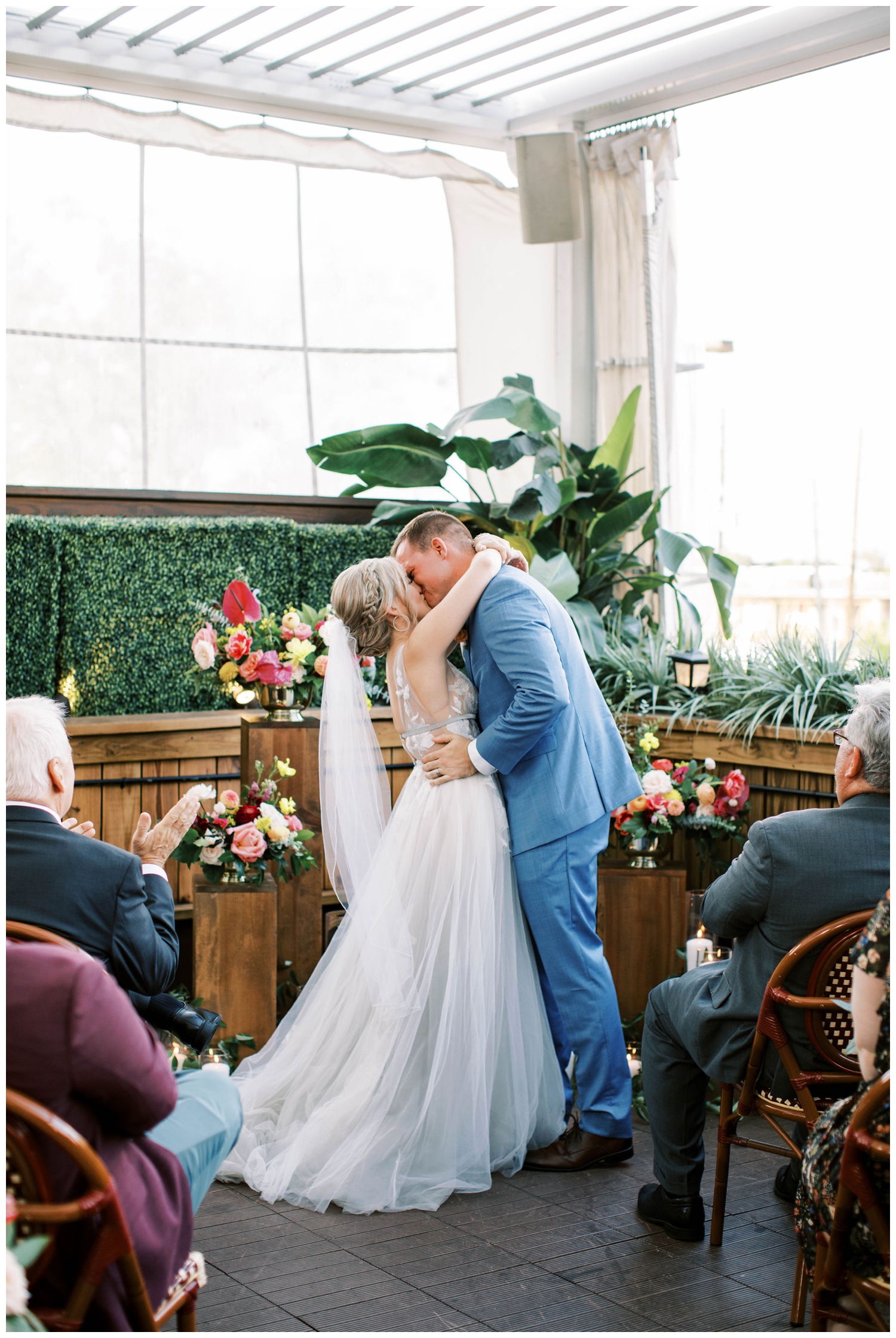 bride and groom kissing during Houston wedding ceremony