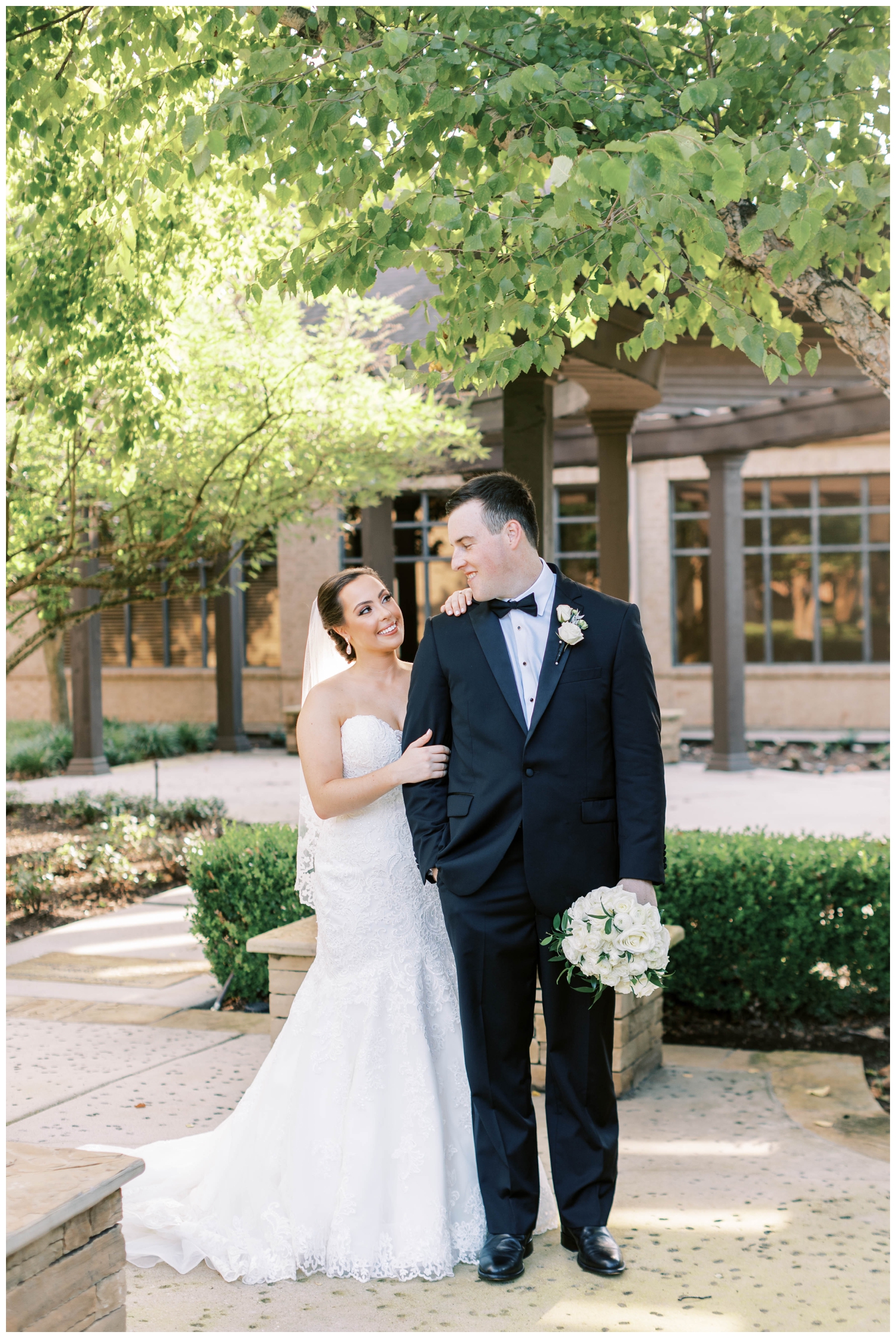 bride and groom embracing outside Houston Junior League wedding