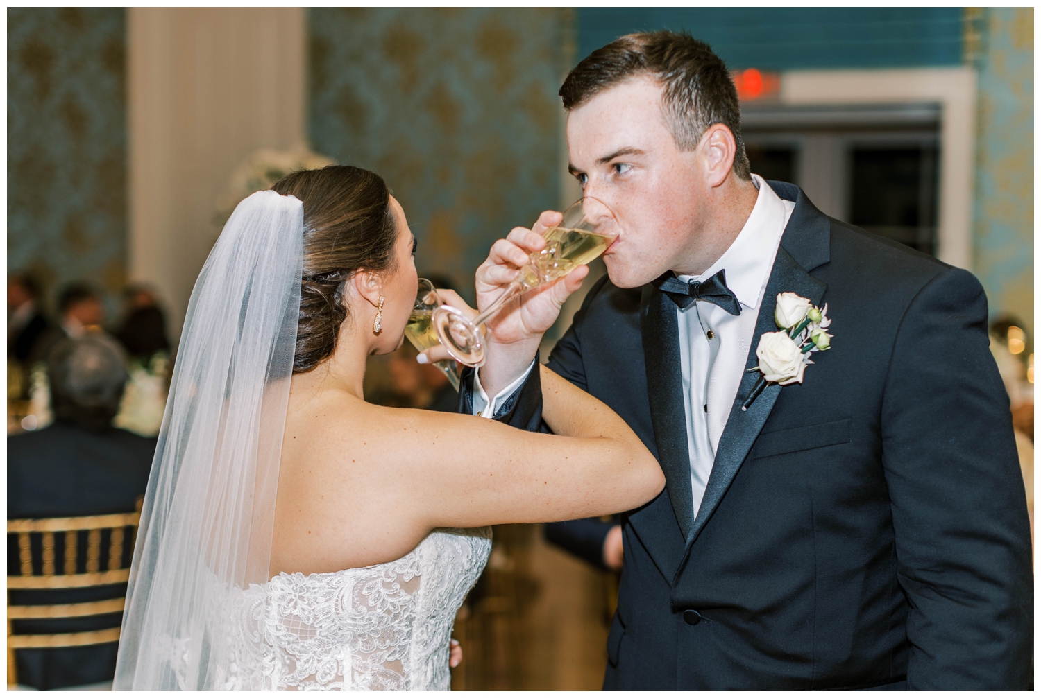 bride and groom toasting and drinking champagne at Houston Junior League wedding reception