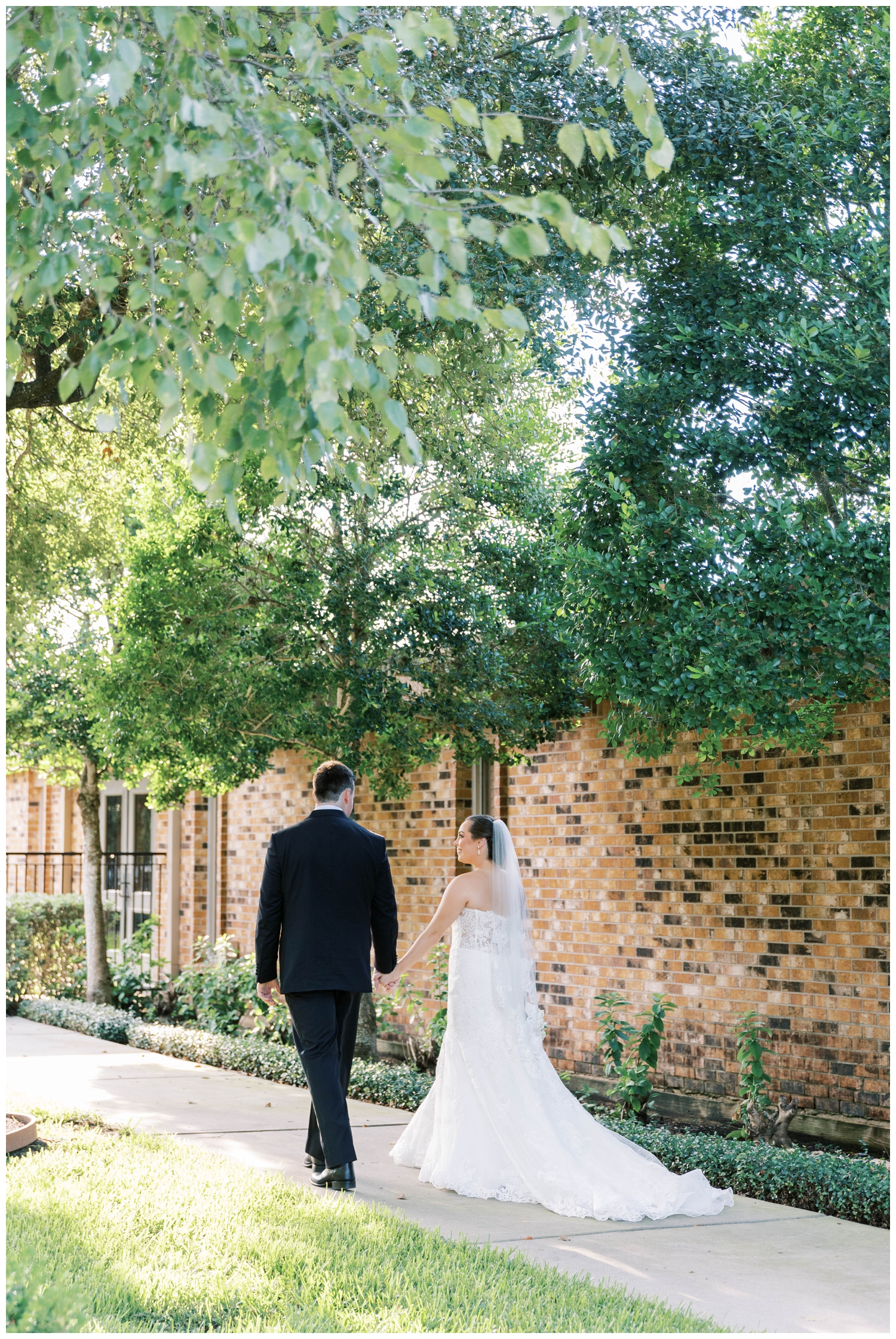 bride and groom walking away from camera at Houston Junior League wedding