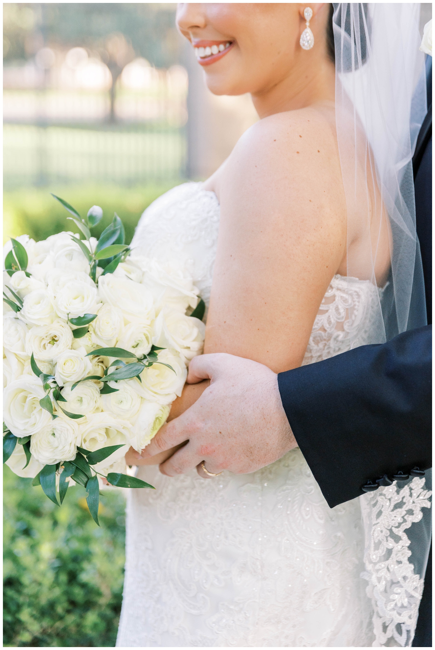 closeup of grooms hand on bride's elbow for portraits at Houston Junior League wedding