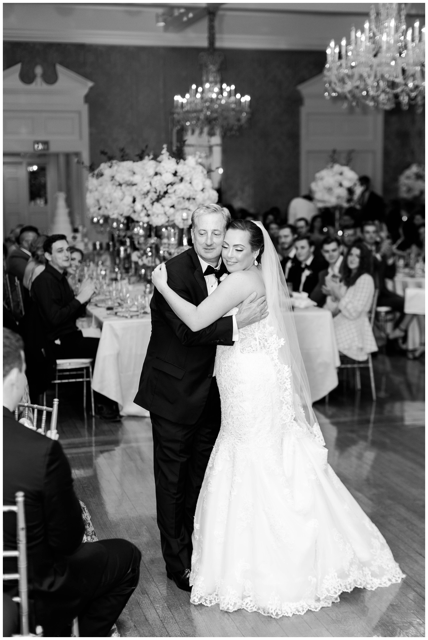 black and white portrait of father and bride hugging at Houston Junior League wedding reception