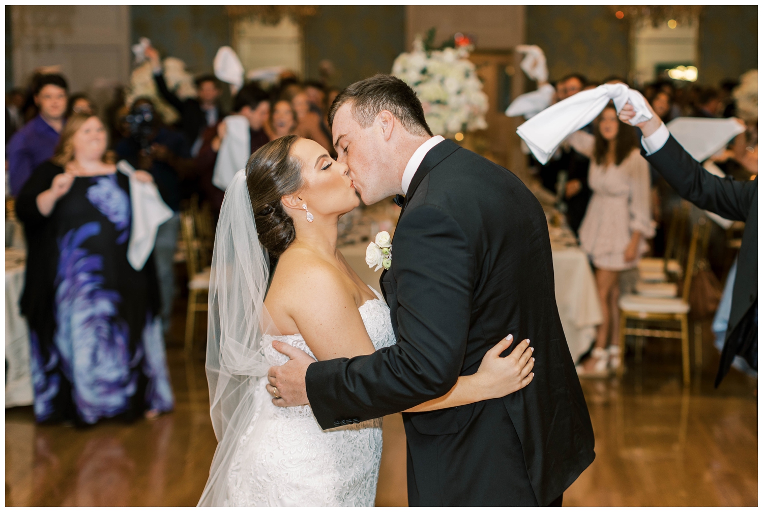 Houston Junior League wedding reception with bride and groom kissing