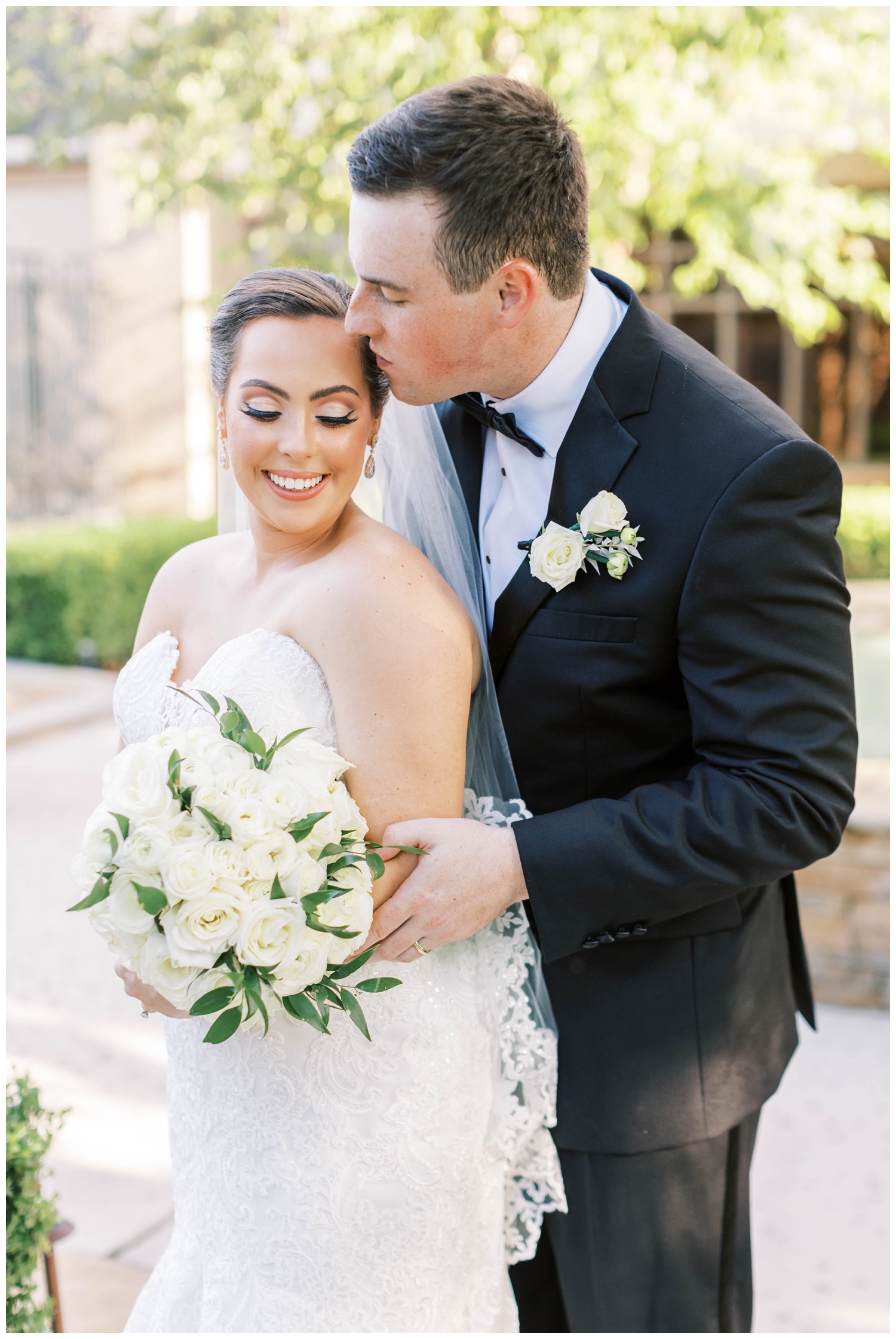 Houston Junior League wedding portrait of groom kissing bride's head