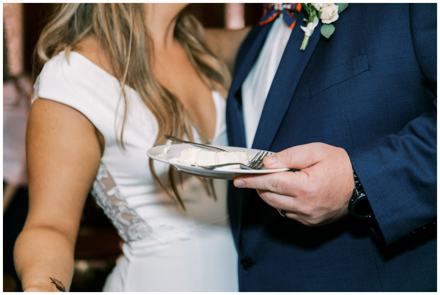 closeup image of groom holding cake plate