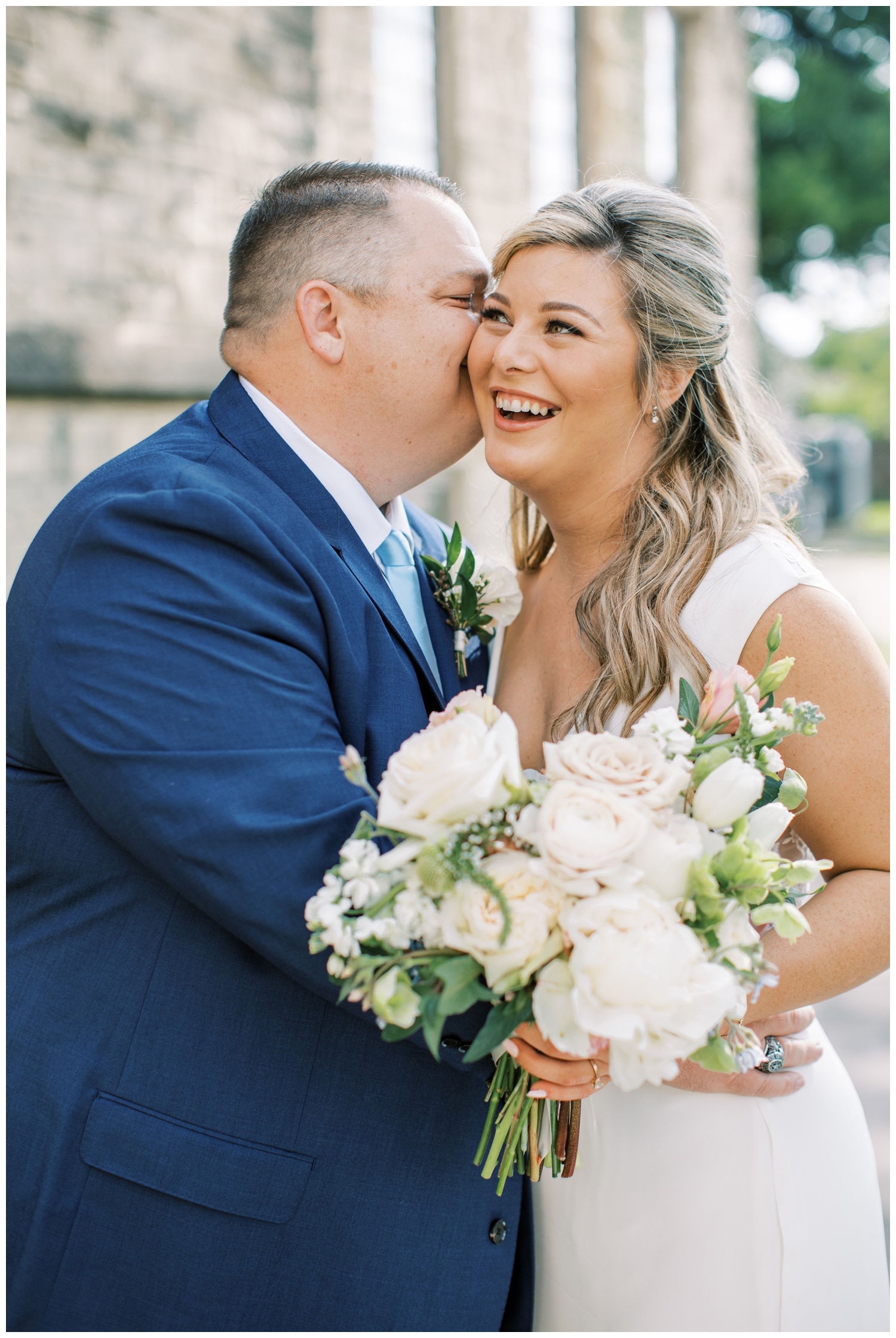 bride laughing with groom and all white bouquet Majestic Metro Wedding