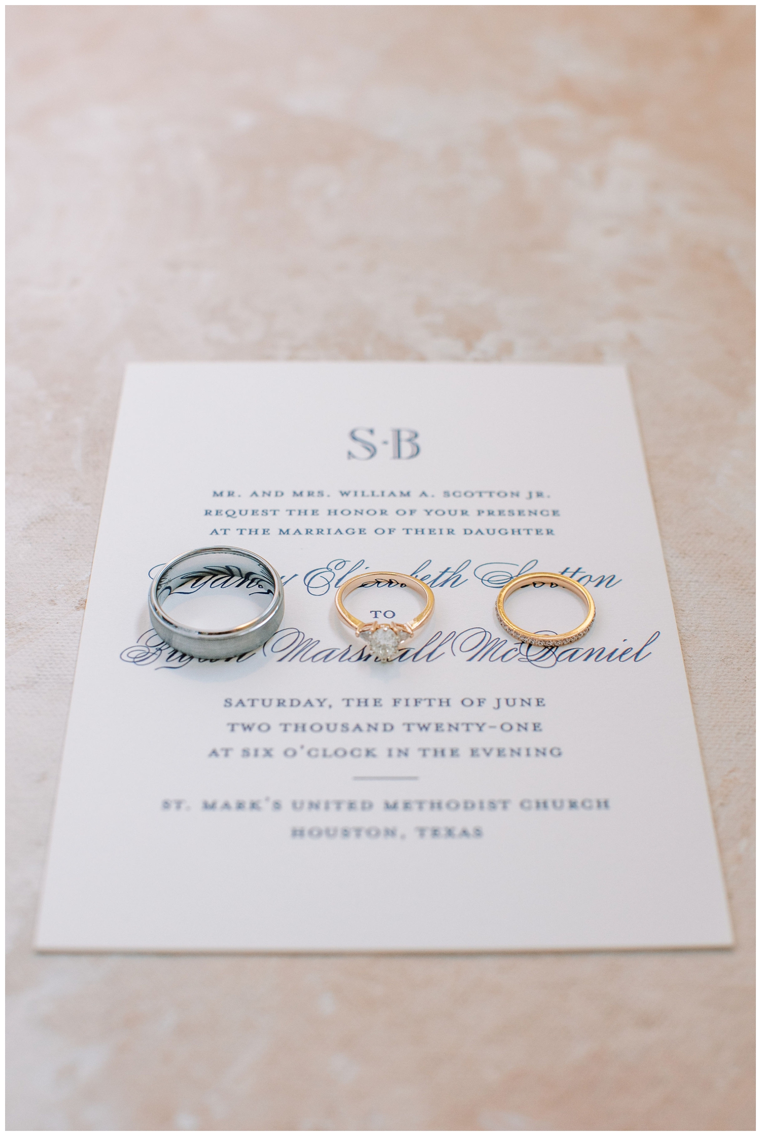 wedding rings on white invitation